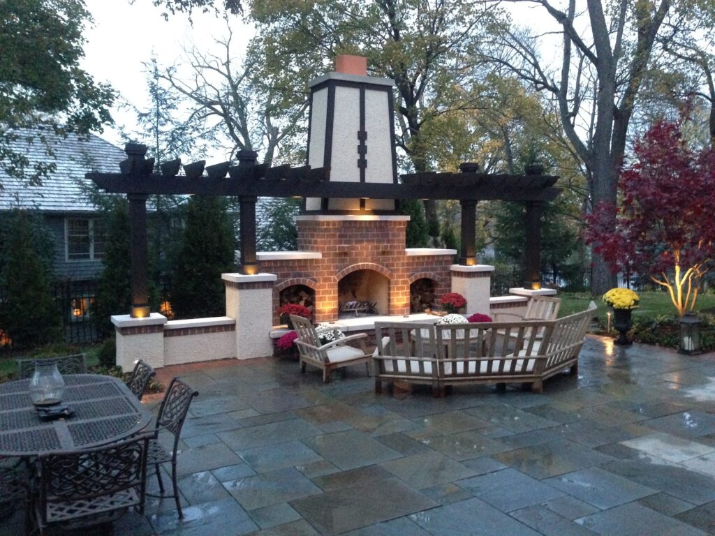 Gorgeous Backyard Patio with furniture, fireplace and sleek brick
